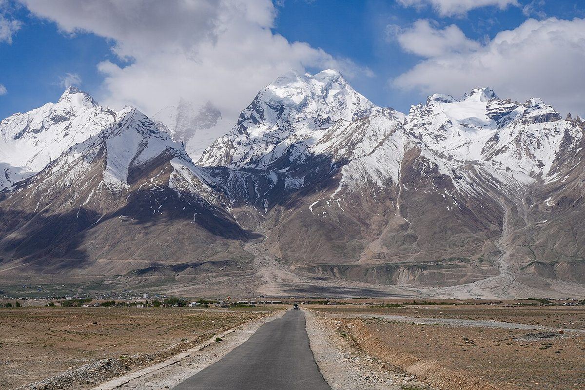 Padum-Pibiting Road from Karsha to Padum, Zanskar range towering 2,400 m (8,000 ft) above Padum (elev. 3,500 m (11,500 ft)). Zanskar, Ladakh, India