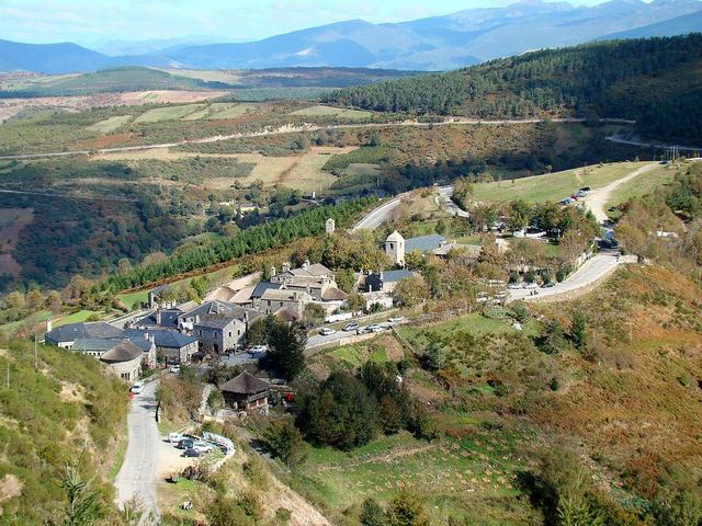 Pedrafita do Cebreiro as seen from a hill west of and above the village. The Way of Saint James enters the village near the bus leaving the parking lot in the upper right part of the photo, goes throu